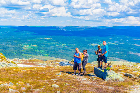 Hemsedal Norway 06. June 2016 Tourists and photographer on trekking path by a beautiful snowy landscape panorama Norway of Hydalen Hemsedal with snowed in Mountains in summer.のeditorial素材