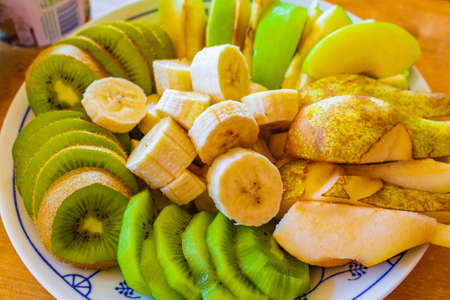 Colorful fruits cut and served as salad on a plate. Very healthy breakfast and food. Hemsedal Norway.の写真素材