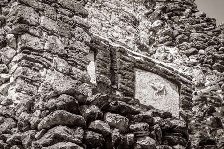 Old black and white picture of the ancient Mayan site with temple ruins pyramids and artifacts in...