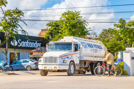 Tulum Mexico February 02, 2022 Trucks dump truck and other industrial vehicles on typical street road and cityscape in Tulum in Mexico.のeditorial素材