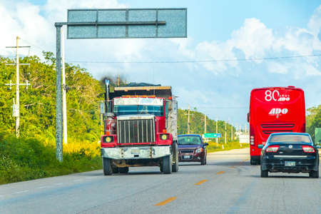 Tulum Mexico February 02, 2022 Trucks dump truck and other industrial vehicles on typical street road and cityscape in Tulum in Mexico.のeditorial素材