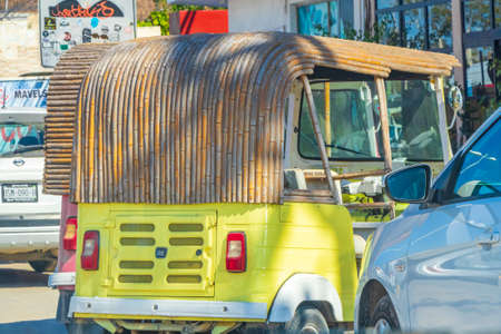 Tulum Mexico February 02, 2022 Driving thru typical colorful street road and cityscape with tuk tuk...