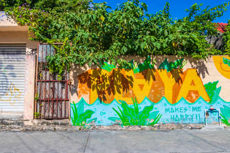 Playa del Carmen Mexico February 04, 2022 Typical street road and cityscape with cars and buildings and wall paintings of Luis Donaldo Colosio Playa del Carmen in Mexico.のeditorial素材