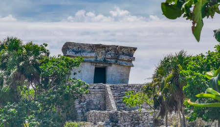 Ancient Tulum ruins Mayan site with temple ruins pyramids and artifacts in the tropical natural jungle forest palm and seascape panorama view in Tulum Mexico.のeditorial素材