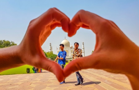 Uttar Pradesh India May 10, 2018 Symbol of love with heart from hands at Taj Mahal in Agra India Mogul marble mausoleum and panorama of the famous 17th century symmetrical gardens.のeditorial素材