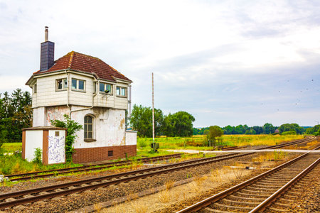 Green and peaceful farming landscapes train station building and railroad tracks from northern Germany.の写真素材