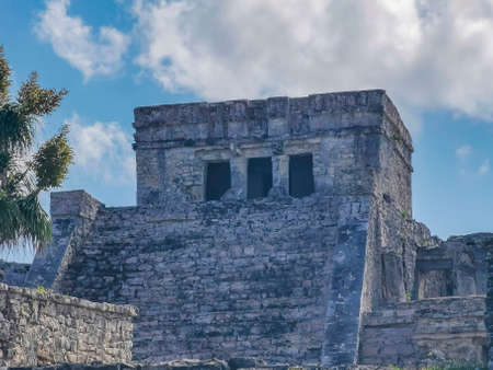 Ancient Tulum ruins Mayan site with temple ruins pyramids and artifacts in the tropical natural jungle forest palm and seascape panorama view in Tulum Mexico.の写真素材