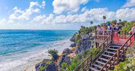 Tulum Mexico February 21, 2022 Ancient Tulum ruins Mayan site with temple ruins pyramids and artifacts in the tropical natural jungle forest palm and seascape panorama view in Tulum Mexico.のeditorial素材