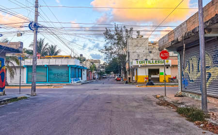 Playa del Carmen Mexico February 21, 2022 Typical street road and cityscape with cars and buildings and wall paintings of Luis Donaldo Colosio Playa del Carmen in Mexico.のeditorial素材