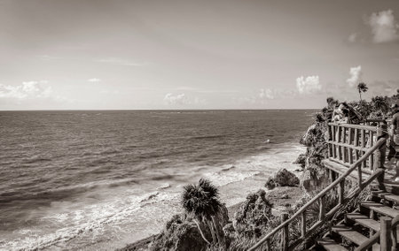 Playa del Carmen Mexico February 04, 2022 Old black and white picture of Ancient Tulum ruins Mayan site with temple ruins pyramids tropical natural jungle forest palm seascape panorama Tulum Mexico.のeditorial素材