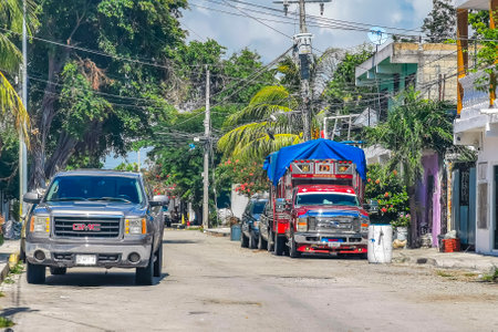 Playa del Carmen Mexico October 09, 2021 Typical street road and cityscape with cars traffic restaurants shops stores people and buildings of Playa del Carmen in Quintana Roo Mexico.の写真素材