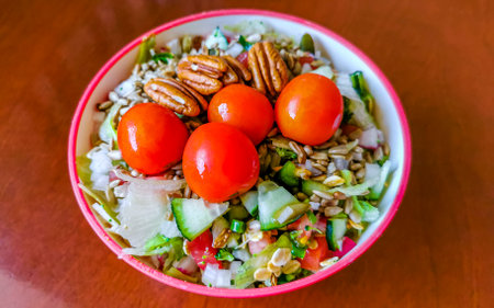 Bowl of healthy salad food with greens cucumber tomato garlic broccoli carrots onion in Playa del Carmen Quintana Roo Mexico.の写真素材