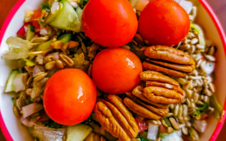 Bowl of healthy salad food with greens cucumber tomato garlic broccoli carrots onion in Playa del Carmen Quintana Roo Mexico.の写真素材
