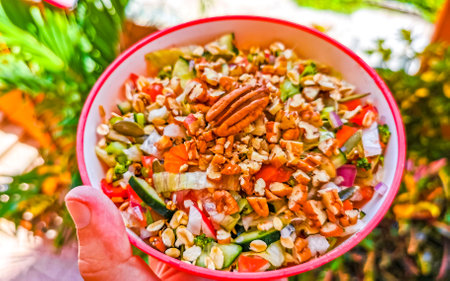 Bowl of healthy salad food with greens cucumber tomato garlic broccoli carrots onion in Playa del Carmen Quintana Roo Mexico.の写真素材
