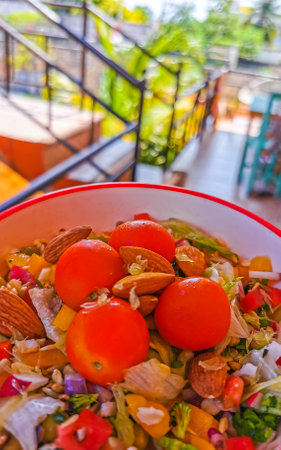 Bowl of healthy salad food with greens cucumber tomato garlic broccoli carrots onion in Playa del Carmen Quintana Roo Mexico.の写真素材