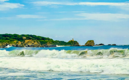 Extremely huge big surfer waves with cliffs rocks boulders stones at the beach in Zicatela Puerto...