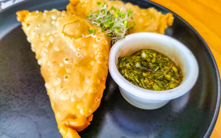 Delicious Argentinian and Mexican empanadas with herb sauce in Playa del Carmen Quintana Roo Mexico.