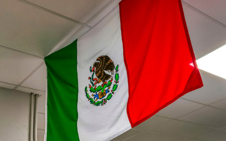 Mexican green white red flag with blue sky and clouds in Zicatela Puerto Escondido Oaxaca Mexico.