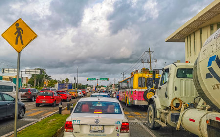 Typical street road and cityscape with cars traffic restaurants shops stores people and buildings of Playa del Carmen in Quintana Roo Mexico.のeditorial素材