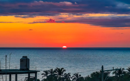Beautiful stunning colorful and golden sunset in yellow orange red on beach and big wave panorama in tropical nature in Zicatela Puerto Escondido Oaxaca Mexico.の写真素材