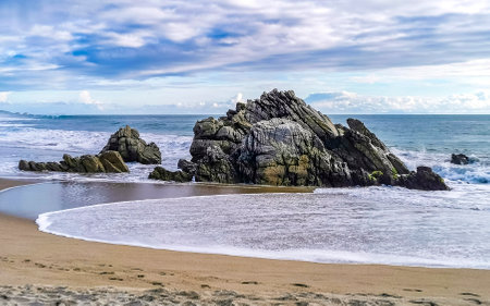 Extremely beautiful huge big surfer waves and rocks on the beach in Zicatela Puerto Escondido Oaxaca...