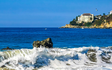 Extremely beautiful huge big surfer waves and rocks on the beach in Zicatela Puerto Escondido Oaxaca...