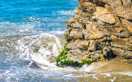 Extremely beautiful huge big surfer waves and rocks on the beach in Zicatela Puerto Escondido Oaxaca Mexico.の写真素材