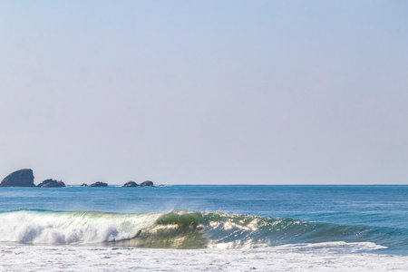 Extremely huge big surfer waves on the beach at La Punta de Zicatela Puerto Escondido Oaxaca Mexico.の写真素材