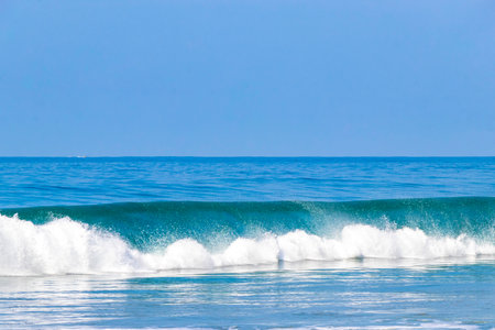 Extremely huge big surfer waves on the beach in Zicatela Puerto Escondido Oaxaca Mexico.の写真素材