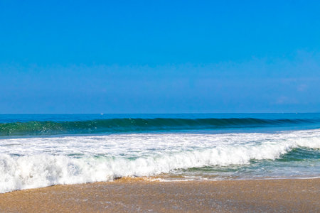 Extremely huge big surfer waves on the beach in Zicatela Puerto Escondido Oaxaca Mexico.