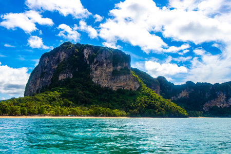 Beautiful tropical paradise panorama view on turquoise water beach mountains hills cliffs and between limestone rocks on Ao Nang Beach in Amphoe Mueang Krabi Thailand in Southeast Asia.の写真素材
