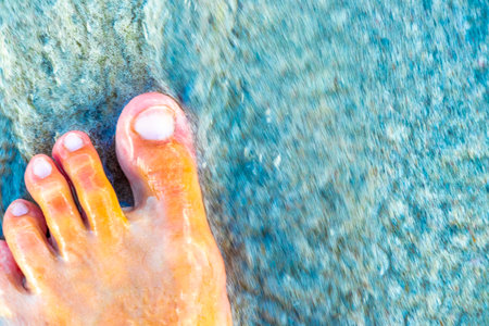 Walking barefoot on the beach sand by the water in Playa del Carmen Quintana Roo Mexico.の写真素材