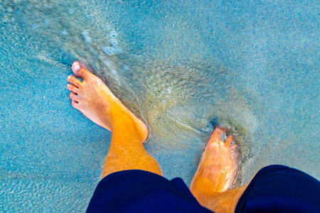 Walking barefoot on the beach sand by the water in Playa del Carmen Quintana Roo Mexico.の写真素材
