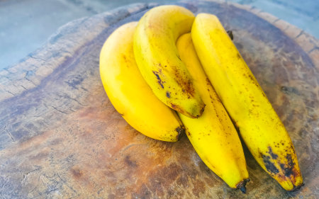 Bananas banana fruit fruits on wooden table in Zicatela Puerto Escondido Oaxaca Mexico.の写真素材