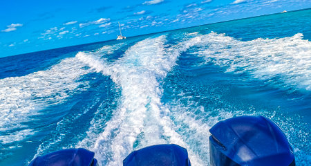 Boats Speedboats Yachts and Jetty in blue turquoise water and sea on Isla Mujeres island in Cancun...
