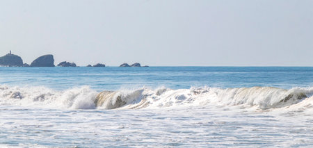 Extremely huge big surfer waves on the beach at La Punta de Zicatela Puerto Escondido Oaxaca Mexico.の写真素材