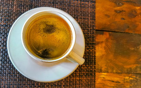 Glass cup of americano black coffee with spoon and plate on table food and drink in the restaurant PapaCharly Papa Charly in Playa del Carmen Quintana Roo Mexico.の写真素材