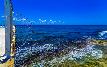 Tropical mexican caribbean beach landscape panorama at Constituyentes pier with corals stones boulders rocks and clear turquoise blue water in Playa del Carmen Mexico.の写真素材