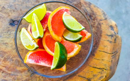 Oranges limes grapes lemon grapefruit citrus fruits on the white plate for preparing breakfast or lunch in Playa del Carmen Mexico.の写真素材