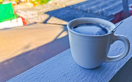 Cup of americano black coffee with spoon and plate on table food and drink in the tropical restaurant in Zicatela Puerto Escondido Oaxaca Mexico.の写真素材