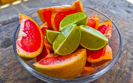 Oranges limes grapes lemon grapefruit citrus fruits on the white plate for preparing breakfast or lunch in Playa del Carmen Mexico.の写真素材