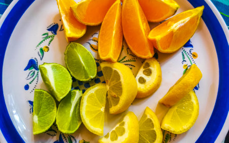 Oranges limes grapes lemon citrus fruits on the white plate for preparing breakfast or lunch in Playa del Carmen Mexico.の写真素材