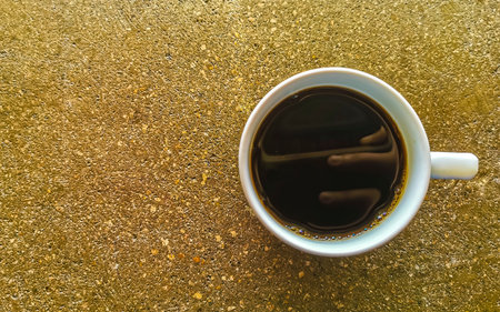 Cup of americano black coffee with spoon and plate on table food and drink in the tropical restaurant in Zicatela Puerto Escondido Oaxaca Mexico.の写真素材