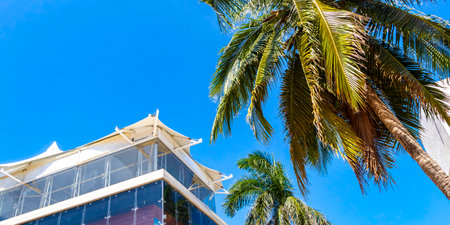 Playa del Carmen Quintana Roo Mexico March 26, 2021 Modern buildings and architecture hotels resorts and apartments in tropical paradise with palm trees in Playa del Carmen Quintana Roo Mexico.のeditorial素材