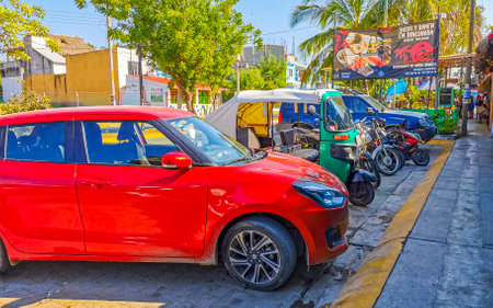 Puerto Escondido Oaxaca Mexico January 16, 2023 Typical beautiful colorful tourist street road and sidewalk with city life cars traffic buildings hotels bars restaurants and people in Zicatela Mexico.のeditorial素材