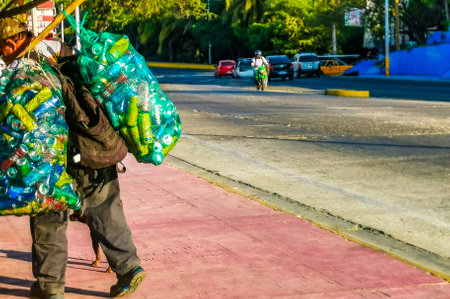 Puerto Escondido Oaxaca Mexico January 20, 2023 Typical beautiful colorful tourist street road and sidewalk with city life cars traffic buildings hotels bars restaurants and people in Zicatela Mexico.のeditorial素材