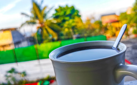 Cup of americano black coffee with spoon and plate on table food and drink in the tropical restaurant in Zicatela Puerto Escondido Oaxaca Mexico.の写真素材