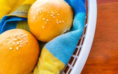 Delicious round buns with sesame seeds on wooden table at El Cafecito in Zicatela Puerto Escondido...