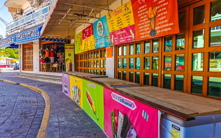 Puerto Escondido Oaxaca Mexico February 01, 2023 Typical beautiful colorful tourist street road and sidewalk with city life cars traffic buildings hotels bars restaurants and people in Zicatela Mexico.のeditorial素材