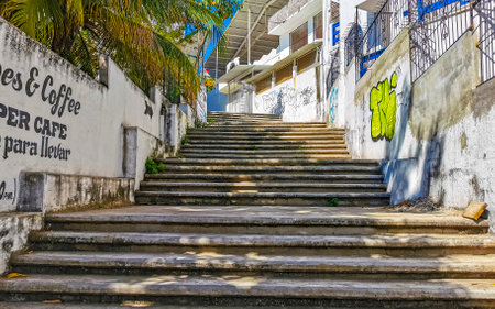 Puerto Escondido Oaxaca Mexico February 15, 2023 Typical beautiful colorful tourist street road and sidewalk with city life cars traffic buildings hotels bars restaurants and people in Zicatela Mexico.のeditorial素材